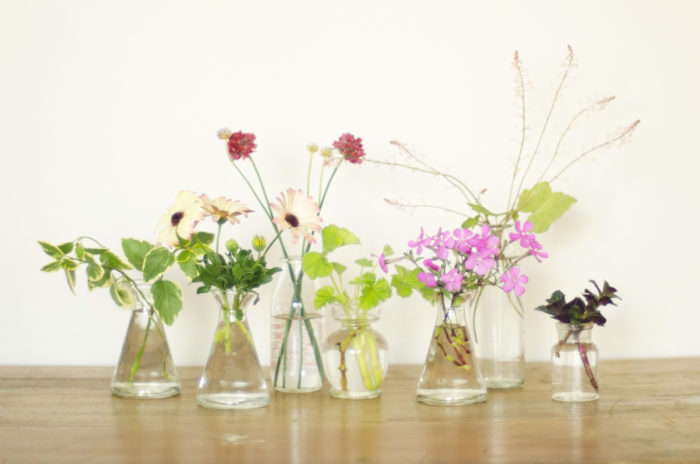  1つのグラスに１種類の花材を2,3本ずつ入れていく。一列に並べておくだけでも華やか。